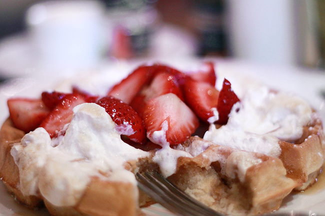 Waffles with whip cream and strawberries